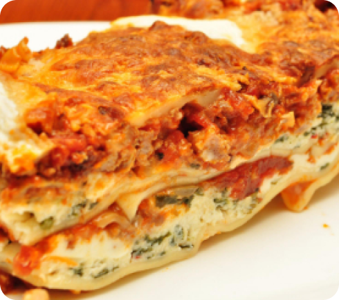 A slice of lasagna on a plate.